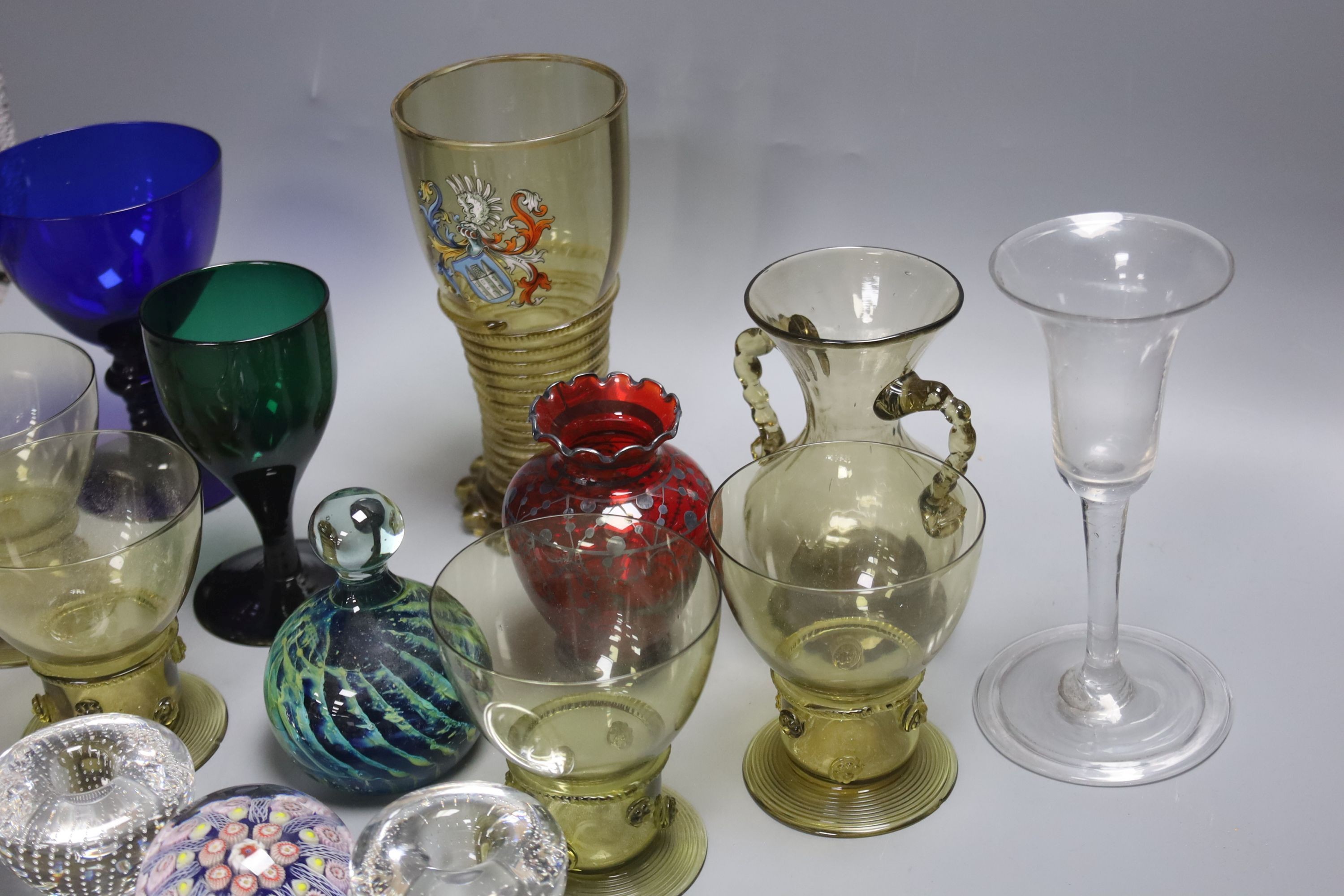 A German glass beaker with enamelled crest, 17.5cm, four Roemers, a millefiori paperweight and coloured glassware